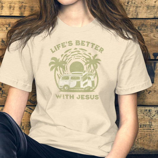 Person wearing a beige t-shirt with a graphic and text against a wooden background