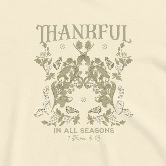 Beige t-shirt with floral design and 'Thankful in All Seasons' text on a beige background