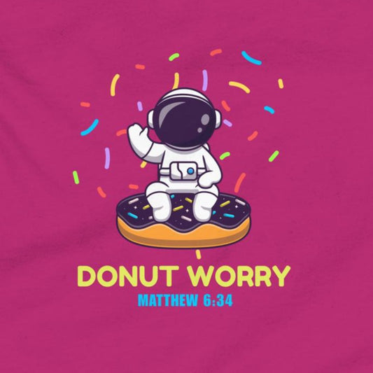 Astronaut on a donut with 'Donut Worry' text and rainbow sprinkles on a pink background
