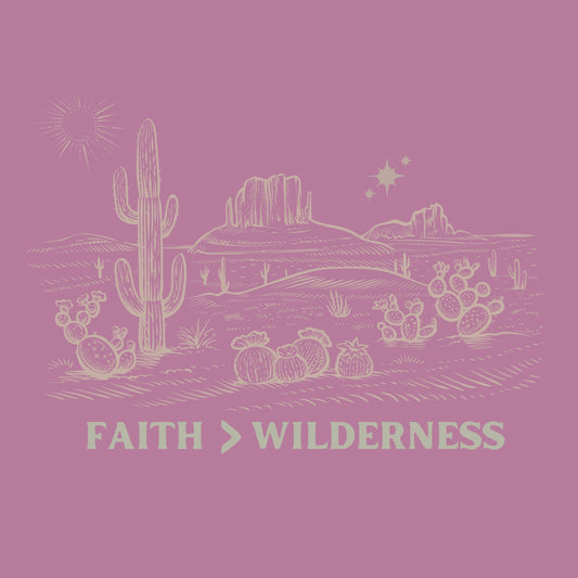 Minimalist t-shirt up close of design. "FAITH > WILDERNESS" — a spiritual, nature-inspired design symbolizing strength and serenity.