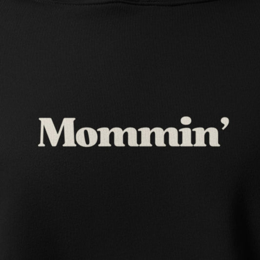 Black shirt with 'Mommin'' text in white on a plain background