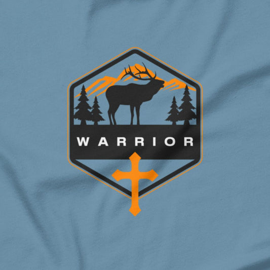 Warrior text with a cross and a silhouette of a stag on a light blue t-shirt.