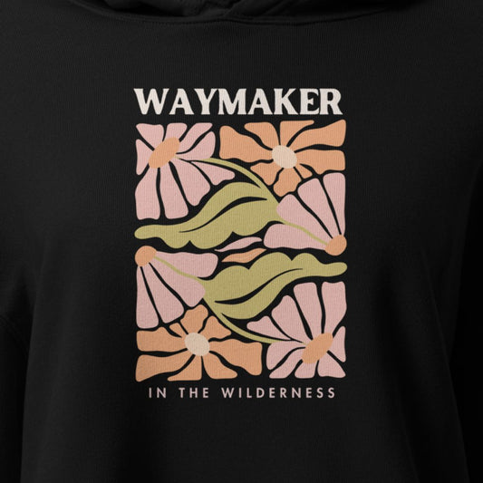 Black hoodie with floral design and 'Waymaker in the Wilderness' text