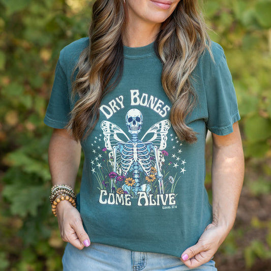 Person wearing a green t-shirt with a skeleton design and Ezekiel 37:4 text. Christian apparel.