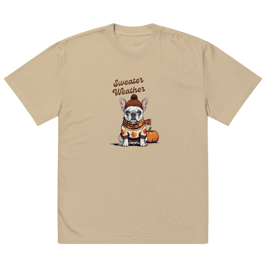 Khaki colored t-shirt with a Frenchie wearing a sweater and beanie hat next to a pumpkin. Text says sweater weather.