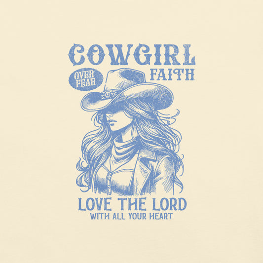 Ivory colored Cowgirl Faith t-shirt featuring a graphic image of a cowgirl wearing a hat and subtext of Love the Lord with all your heart.
