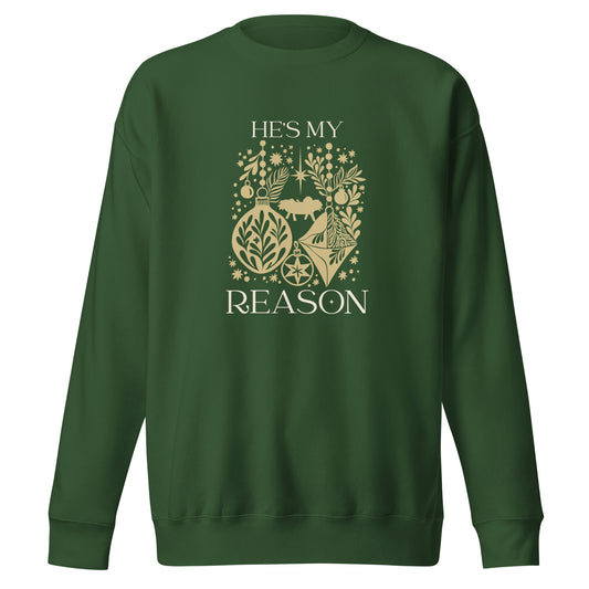 Gold "He is my reason" text with silhouette collage of ornaments, baby Jesus, stars, snowflakes on a forest green colored sweatshirt