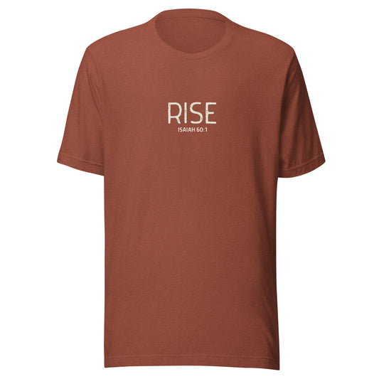 Heather clay “Rise – Isaiah 60:1” Christian t-shirt laid flat; minimalist design, soft cotton fabric, faith-inspired apparel with uplifting message.