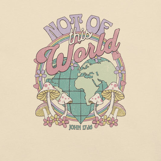 Retro pastel ‘Not of This World’ Christian t‑shirt design featuring globe, rainbow, flowers, mushrooms, and John 17:16 on a heather natural colored Bella + Canvas tee.