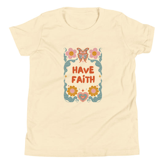 Have faith text on a natural colored t-shirt. Surrounded by smiling flowers, hearts and a butterfly.
