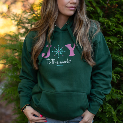 Person wearing a green hoodie with a pink and white design, standing outdoors.
