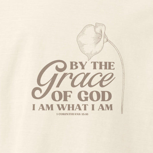Up close of design on Vintage white colored Grace of God tee with lily and 1 Corinthians 15:10.  Faith message on Christian shirt.