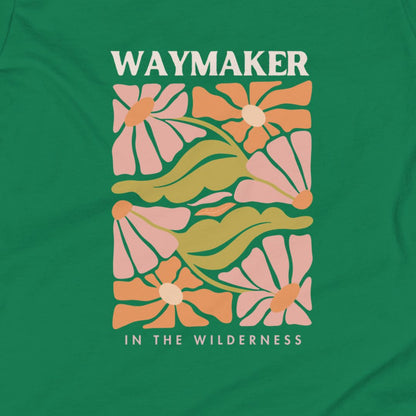 Green t-shirt with floral design and 'Waymaker in the Wilderness' text on a green background