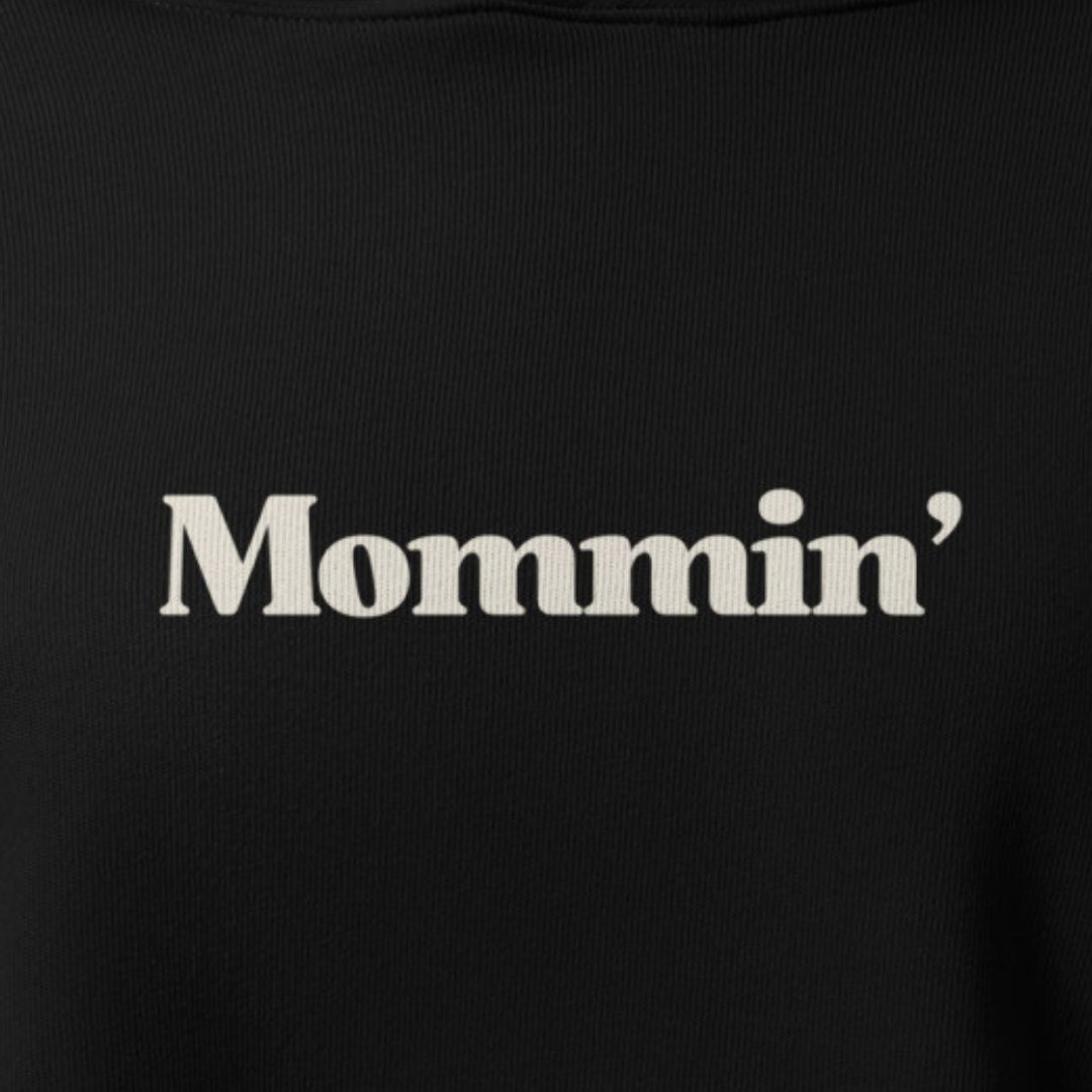 Black shirt with 'Mommin'' text in white on a plain background
