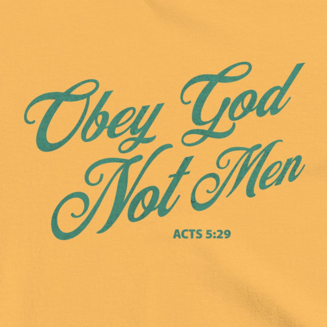 Obey God Not Men script font on a mustard colored t-shirt