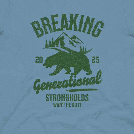 Light blue t-shirt with green graphic design featuring a bear, mountains, and text on a light blue background.