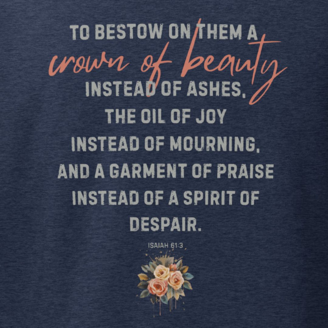 Navy blue shirt with inspirational quote found in Isahiah 61:3 and floral design on a dark background. This is the back of the shirt.