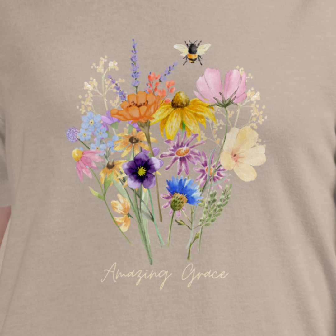 T-shirt with colorful floral design and 'Amazing Grace' text on a beige background