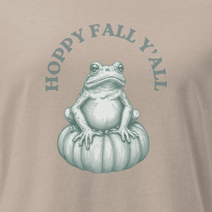 T-shirt with a frog on a pumpkin and 'Hoppy Fall Y'all' text on a beige background