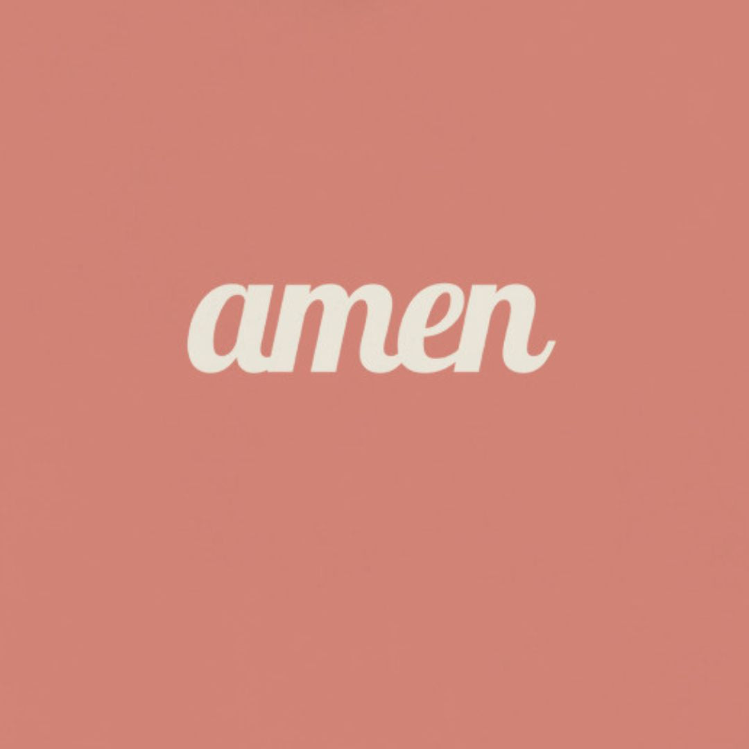 The word 'amen' in white text on a dust rose colored hoodie, up close view