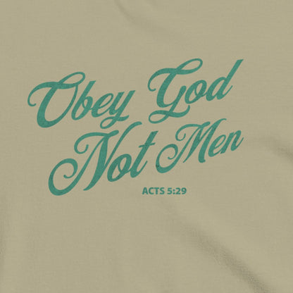 Khaki colored shirt with teal text 'Obey God Not Men' and 'Acts 5:29' in green letters