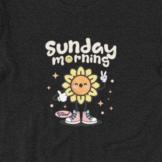 Heather black t-shirt with a cartoon sunflower character and 'Sunday morning' text on a dark background