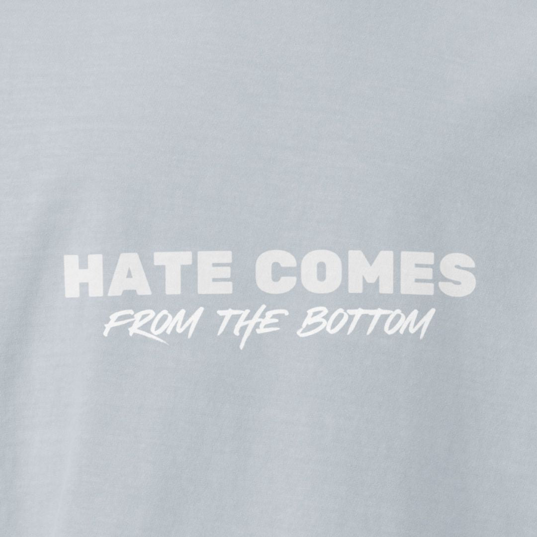 Light washed denim colored t-shirt with 'Hate Comes From The Bottom' text in white 