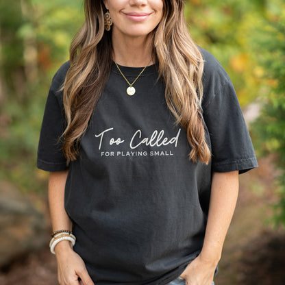 Model wearing Too Called For Playing Small oversized t-shirt while outside. Faith based shirt, modern style.