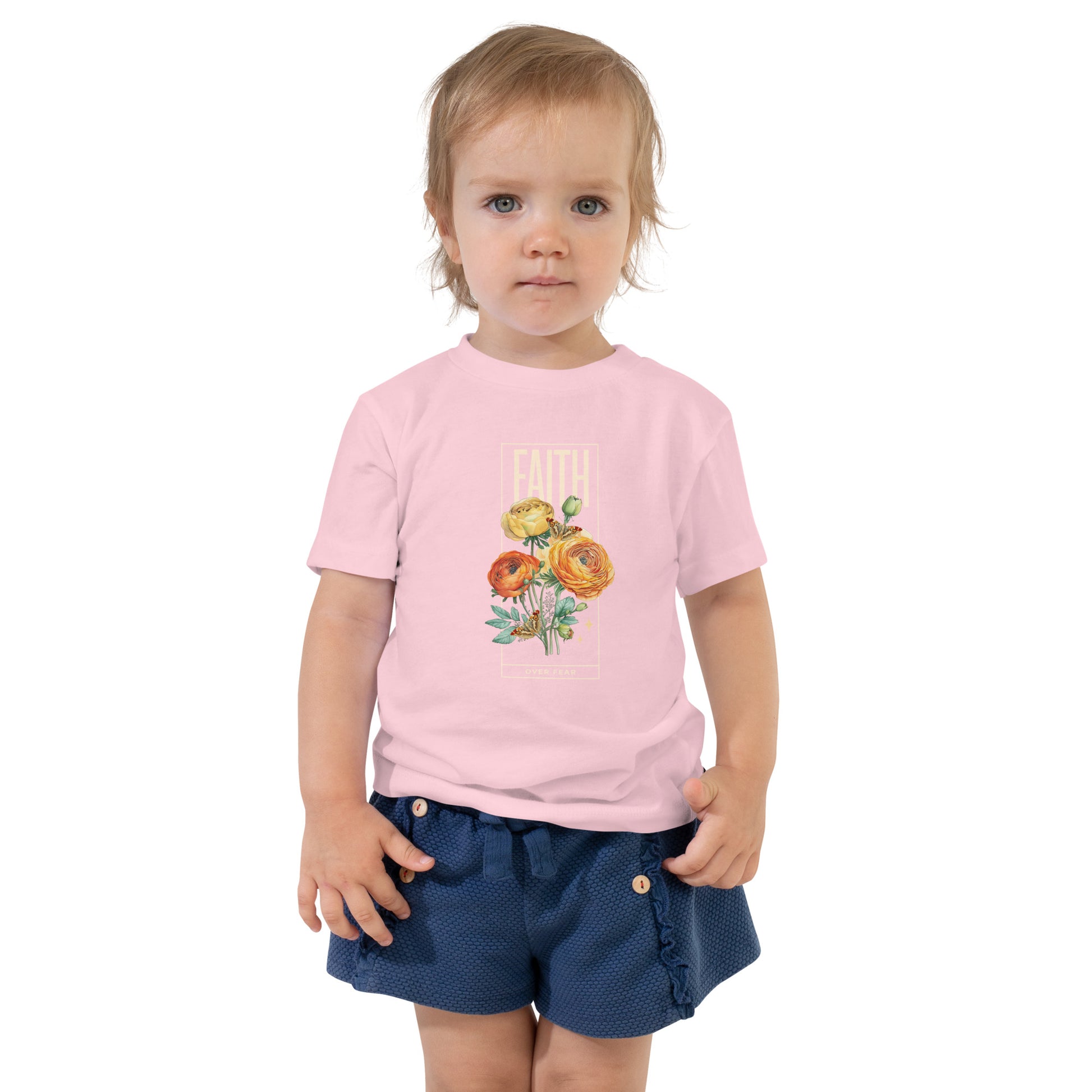 Toddler wearing pink Faith Over Fear tee with colorful roses and butterflies.