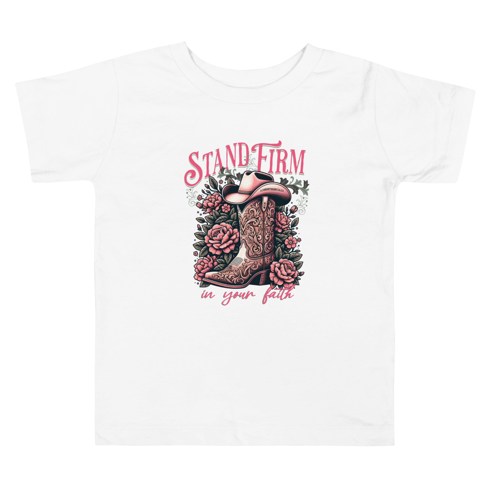 Christian graphic tee featuring a cowboy boot and floral design with the inspirational phrase “Stand Firm in Your Faith” on a pink background. Includes Bible verse 1 Corinthians 16:13 inscribed on the hat. Faith-based western apparel on white t-shirt.