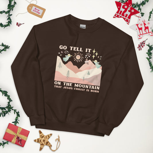 Dark chocolate colored sweatshirt with image of angels playing trumpets over the hills and mountains, with star of Bethlehem and doves in the background. Go tell it on the mountain that Jesus is born.