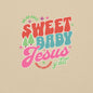 Close-up of the Sweet Baby Jesus design on a sand-colored Christmas sweatshirt.