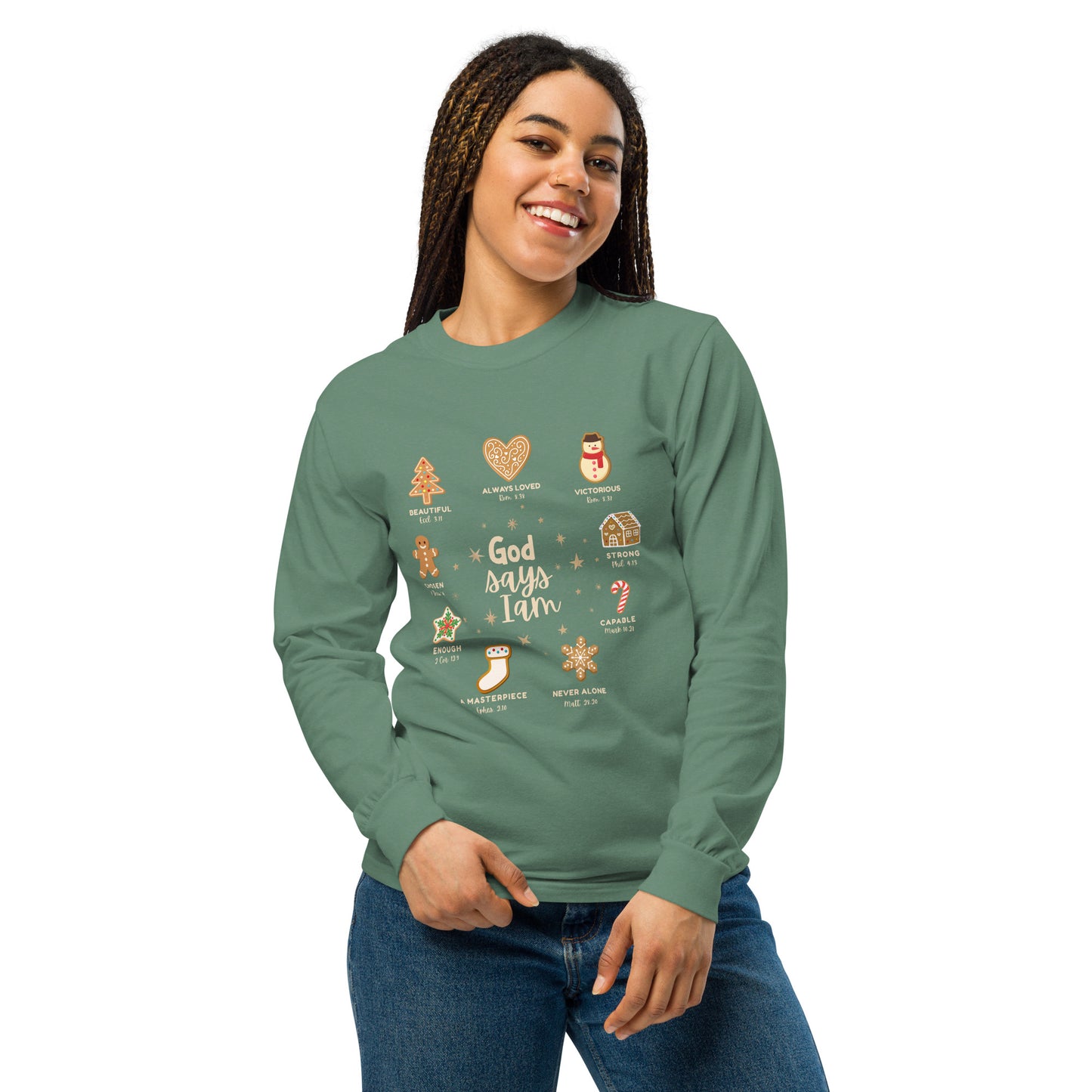 Model wearing a green long sleeve tee that has decorated Christmas cookie images listed next to a quality that God says I am. Christian apparel.