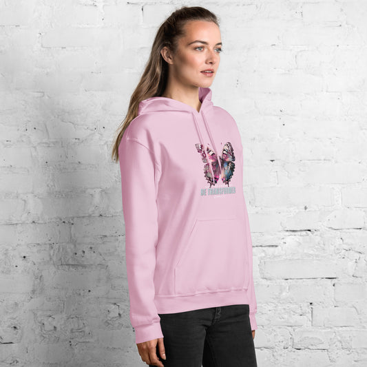 Female model wearing pink hoodie with butterfly design with text 'Don't be conformed, be transformed' and Bible verse reference.