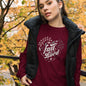 Maroon long sleeve t-shirt on a woman featuring a heart-shaped floral design, symbolizing devotion and autumnal beauty."