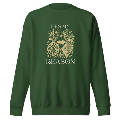 Gold "He is my reason" text with silhouette collage of ornaments, baby Jesus, stars, snowflakes on a forest green colored sweatshirt