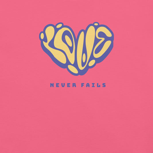 Charity pink t-shirt with heart-shaped ‘Love Never Fails’ graphic in yellow and blue.
