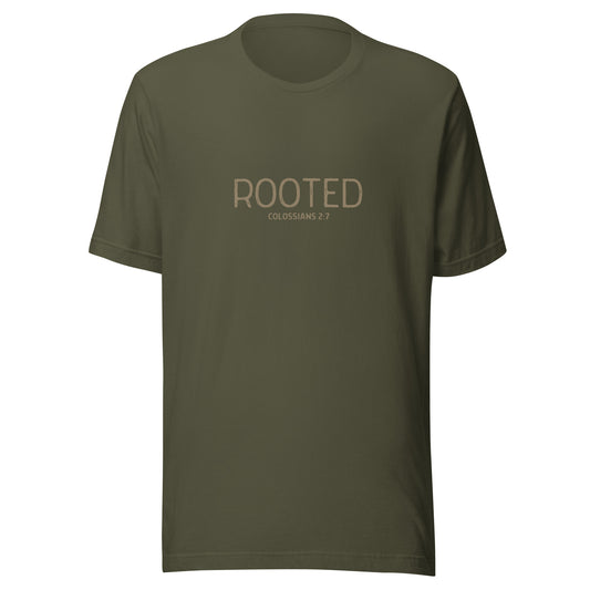 Military green “Rooted – Colossians 2:7” Christian t-shirt laid flat; minimalist design, soft cotton fabric, faith-inspired apparel with spiritual message.