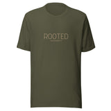 Military green “Rooted – Colossians 2:7” Christian t-shirt laid flat; minimalist design, soft cotton fabric, faith-inspired apparel with spiritual message.