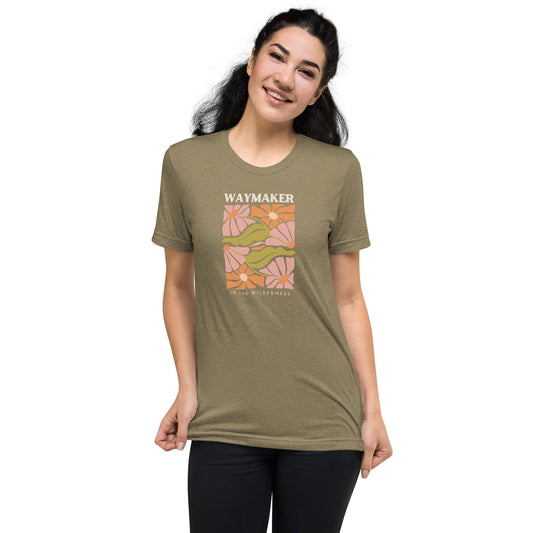 Model wearing olive colored Waymaker Boho T-Shirt with floral design and faith-inspired text 
