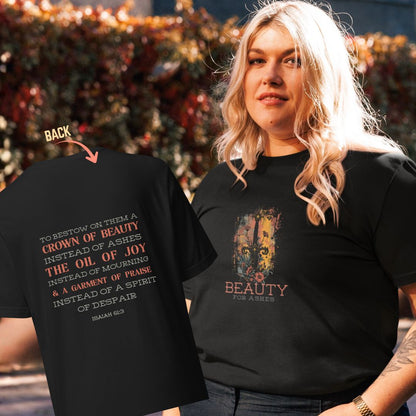 Person wearing a black t-shirt with sword and floral design on front, displaying back of black t-shirt with Isaiah 61:3 verse. Beauty for ashes.