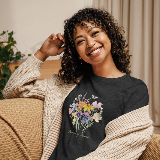 Woman wearing black t-shirt with colorful floral design and 'Amazing Grace' text 