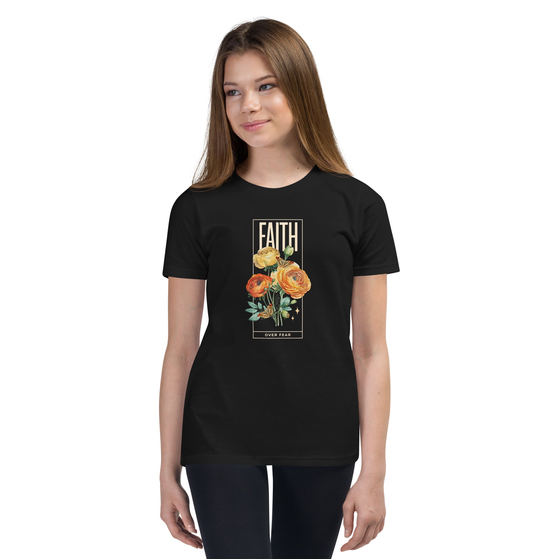 Girl wearing black Faith Over Fear t-shirt with colorful roses and butterflies.